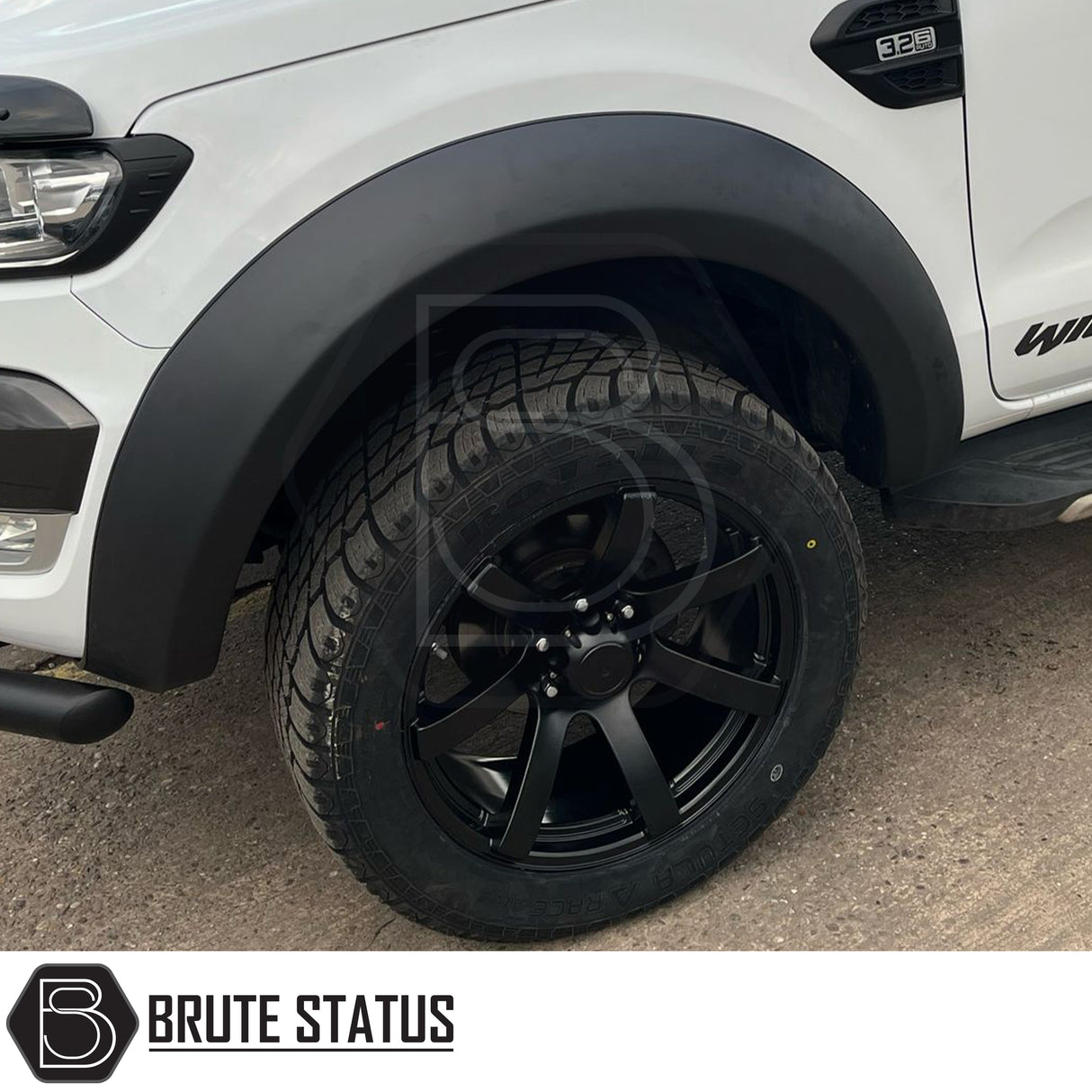 AXE Wheels Quake in Matt Black, showcasing a close-up of the alloy wheel rim with a distinctive red logo, highlighting its design and craftsmanship.