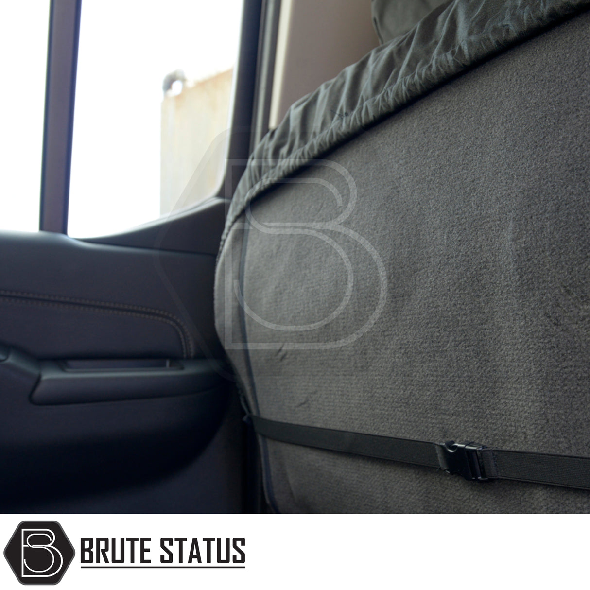 Brute Status seat-back protector in a Nissan Navara, showcasing a tailored fit with adjustable buckle, enhancing interior protection and style.