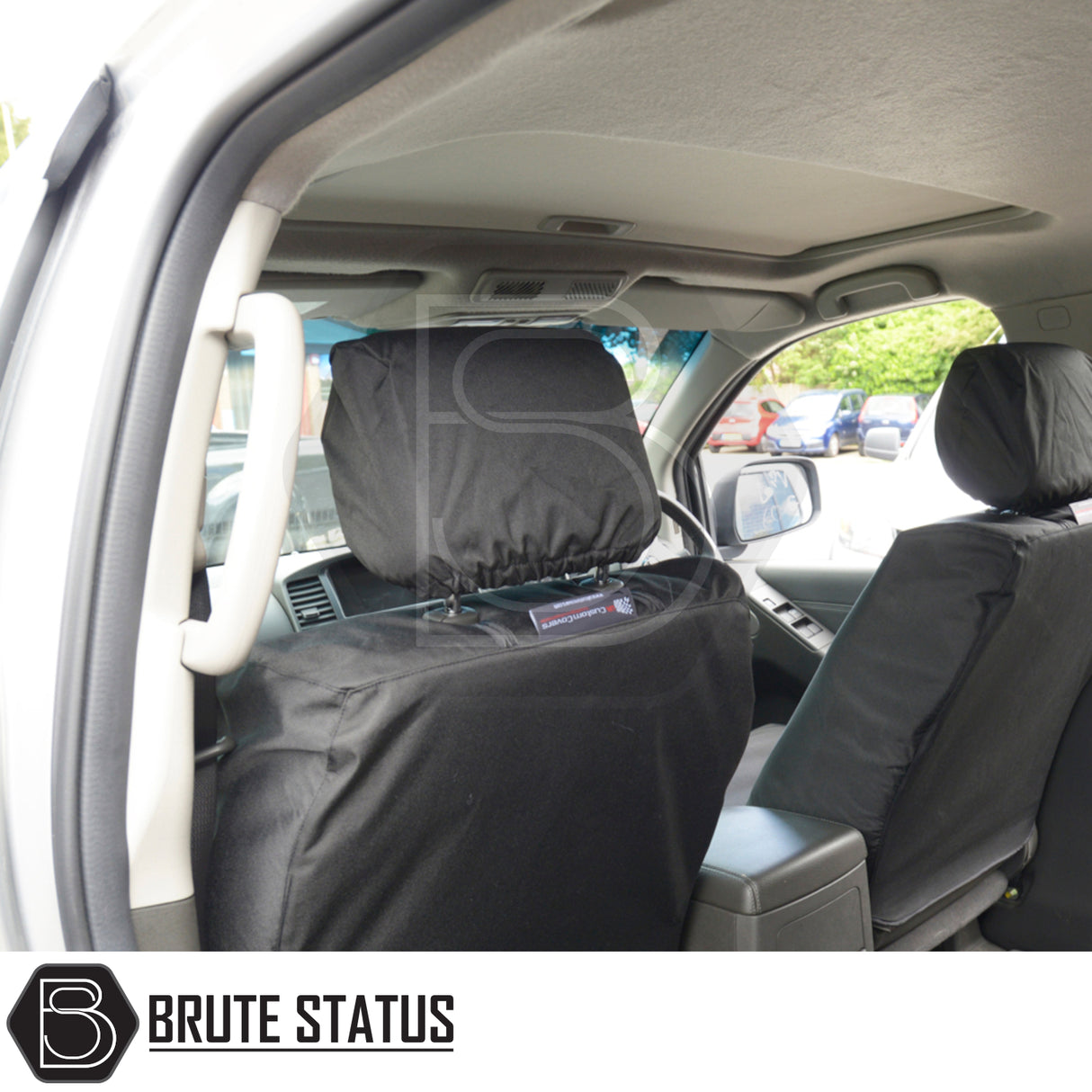 Nissan Navara 2005-2015 D40 Double Cab Cotton-Backed PU Seat Covers fitted on front seats, showcasing tailored fit and protective design with visible center console and parking lot through windows.