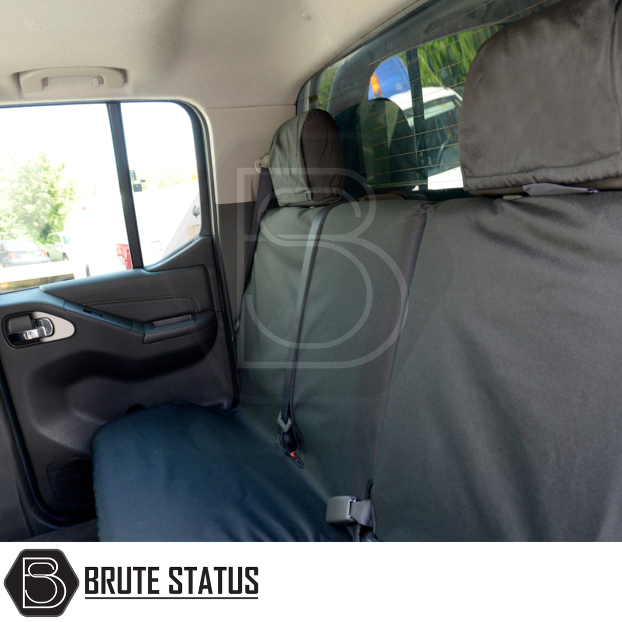 Black protective seat cover on Nissan Navara 2005-2015 D40 Double Cab's rear seats, featuring Brute Status logo, tailored fit, waterproof material.