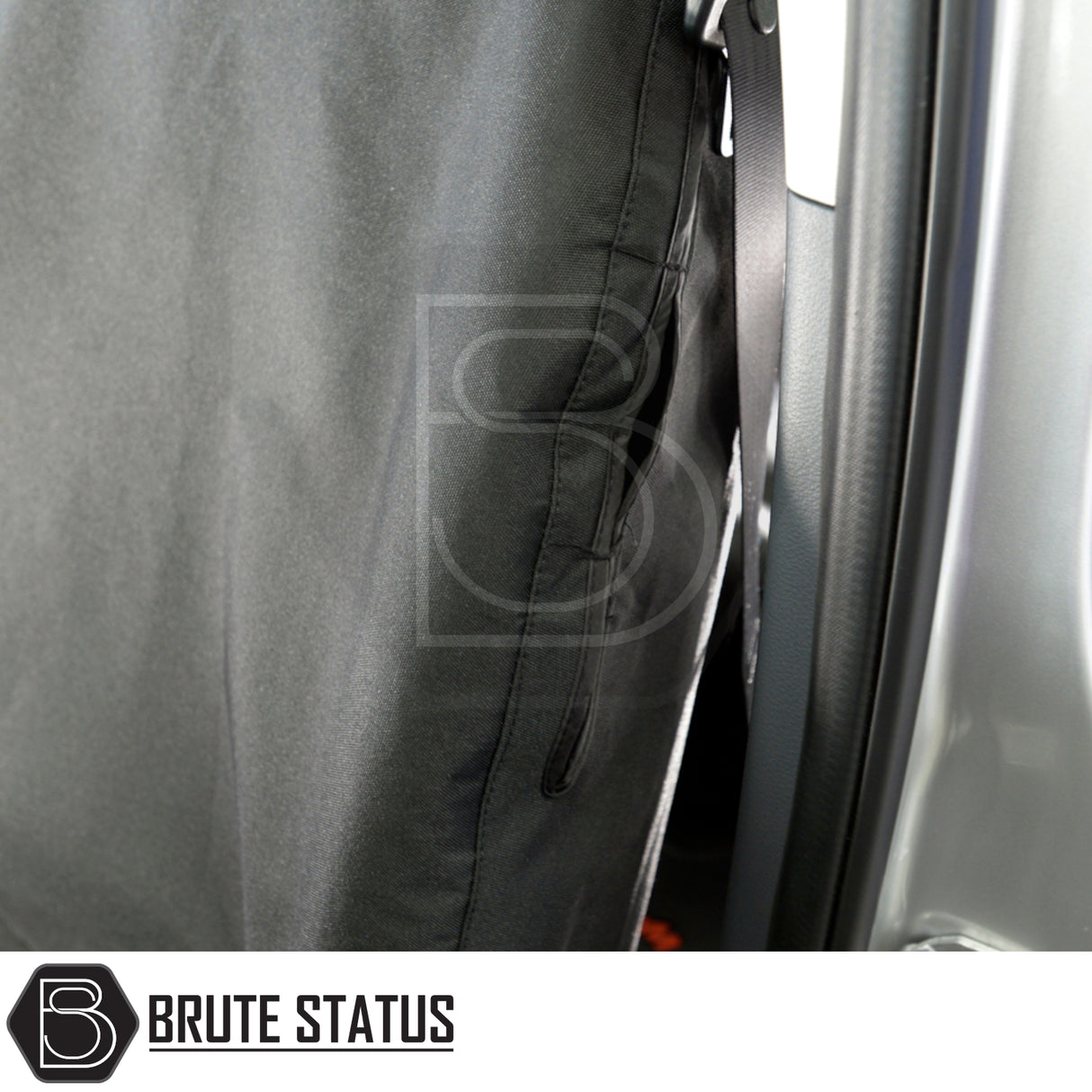 Brute Status black fabric barrier/seat cover in a Ford Ranger 2012-2022, tailored for protection, featuring a Brute Status logo and heavy-duty material.