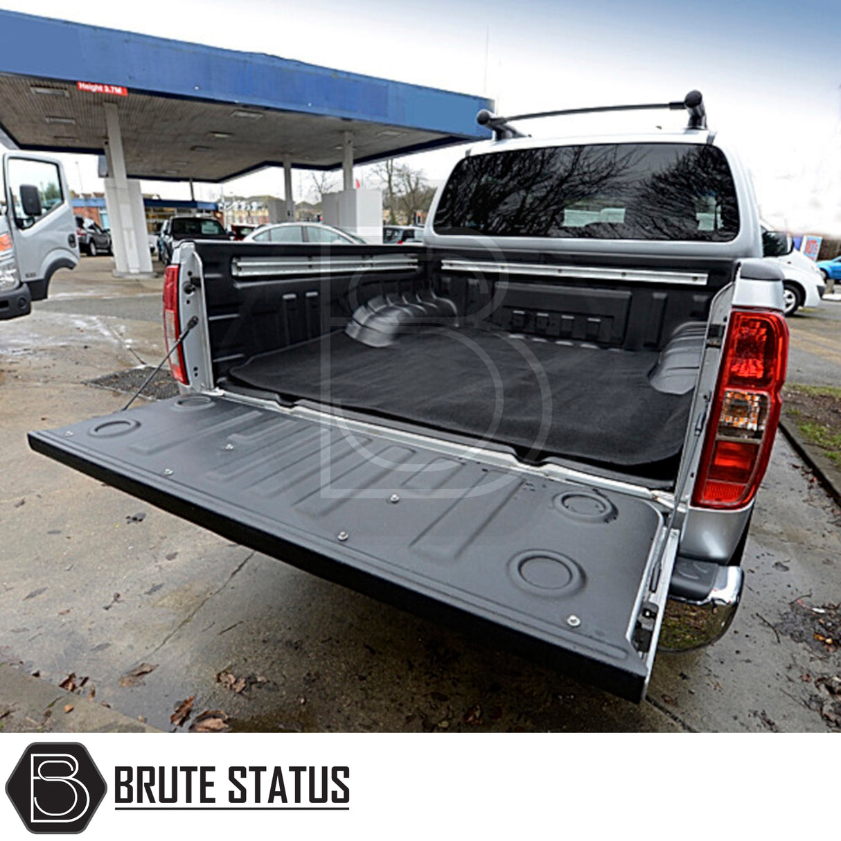 Nissan Navara 2005-2015 D40 Carpet Load Bed Liner in a truck's open trunk, showcasing its precise fit and non-slip backing.