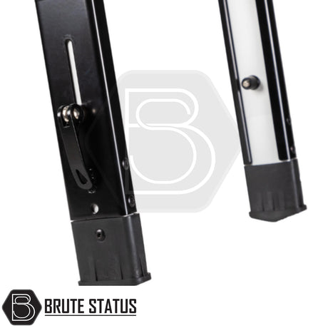 Close-up of Brute Status branded ARB Altitude Tent Ladder Extension's adjustable telescoping metal support legs with locking levers and plastic feet for rooftop tent use.