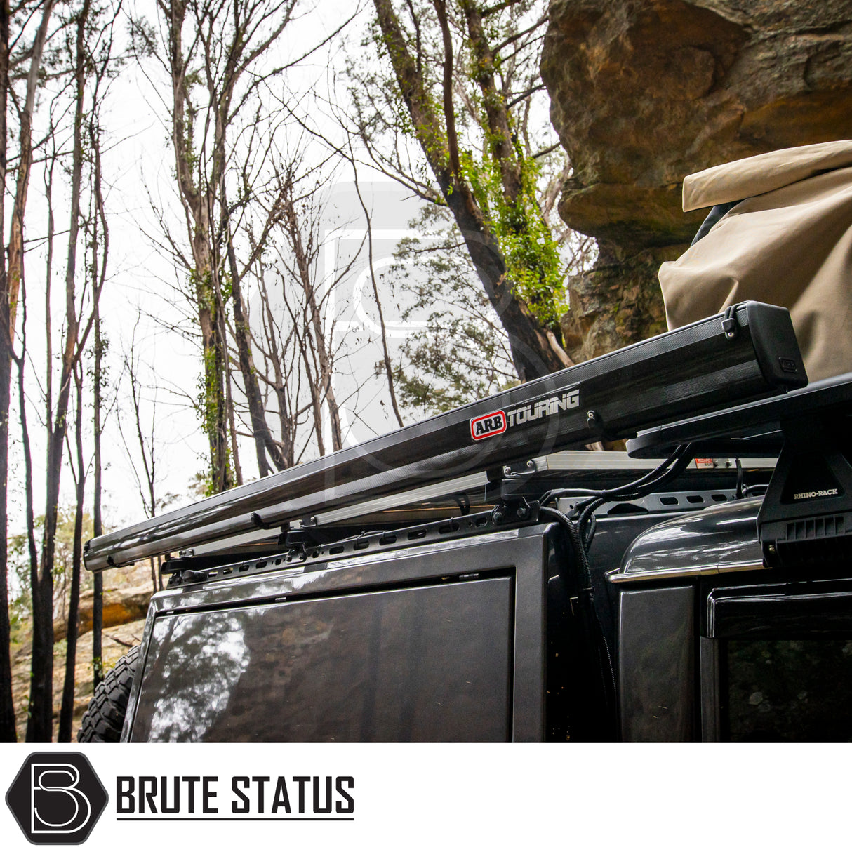 Side view of a 4x4 with ARB Aluminium Case Black Awning & LED Light Kit, stowed on roof rack, showcasing rugged, off-road accessory setup.
