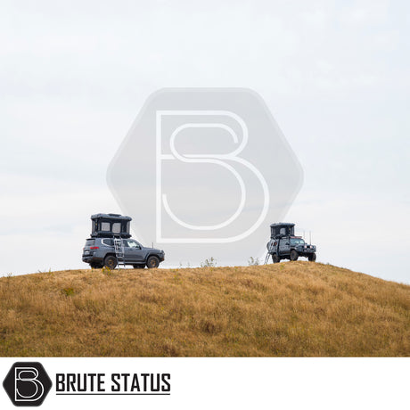 Two off-road SUVs with ARB Altitude Rooftop Tents on a grassy hill, showcasing automated setup and innovative design for luxury off-grid camping.