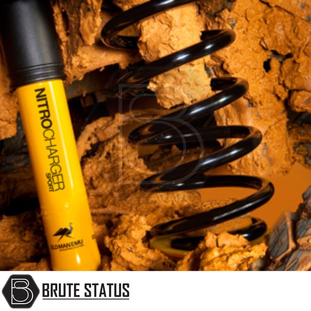 Toyota Hilux 2016+ MK8 & MK9 Old Man Emu Nitrocharger 40mm Suspension Lift Kit with yellow shock absorber and black coil spring caked in orange mud.
