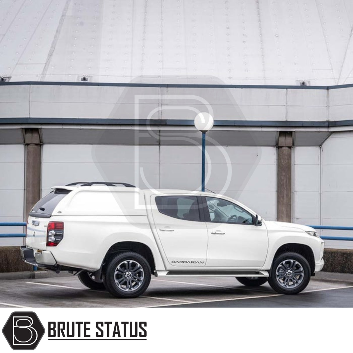 Mitsubishi L200 with Truckman L-Series Hardtop Canopy, featuring remote locking and enhanced security, parked in front of an industrial building.