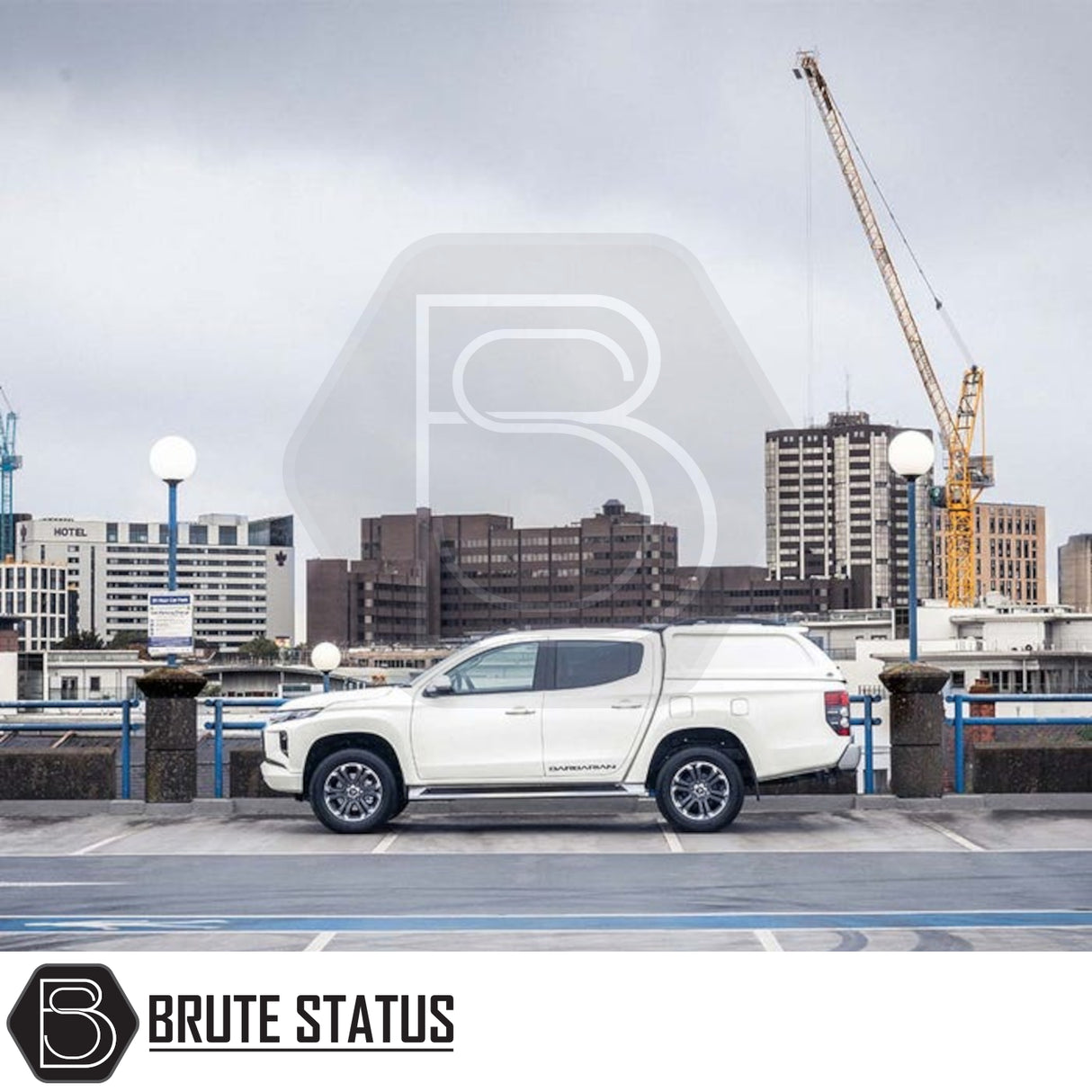 Fiat Fullback/Mitsubishi L200 Truckman L-Series Hardtop Canopy on white pickup, parked atop city car park; enhances bed capacity and security.