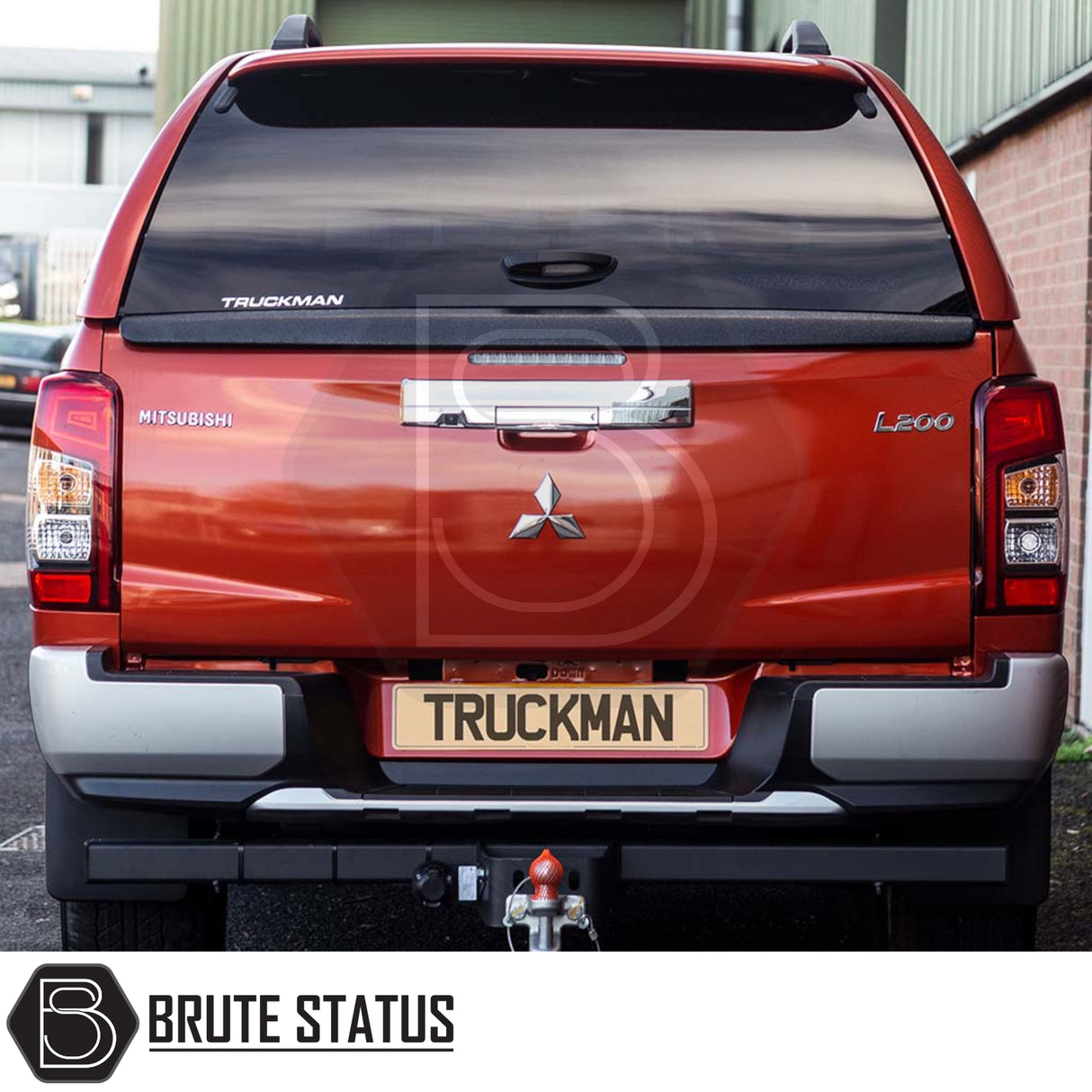 Rear view of a red Mitsubishi L200 with a Truckman GLS hardtop canopy, showcasing remote locking, tinted windows, and integrated features for enhanced storage and security.