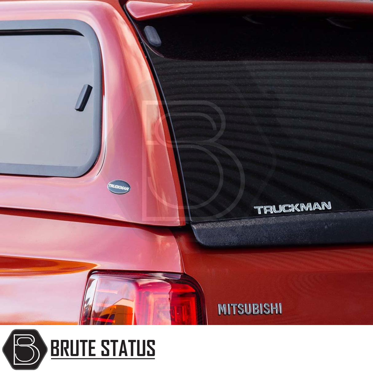 Rear view of a Mitsubishi pickup truck fitted with a Truckman GLS hardtop canopy, showcasing the MITSUBISHI badge and canopy's sporty, lockable design.
