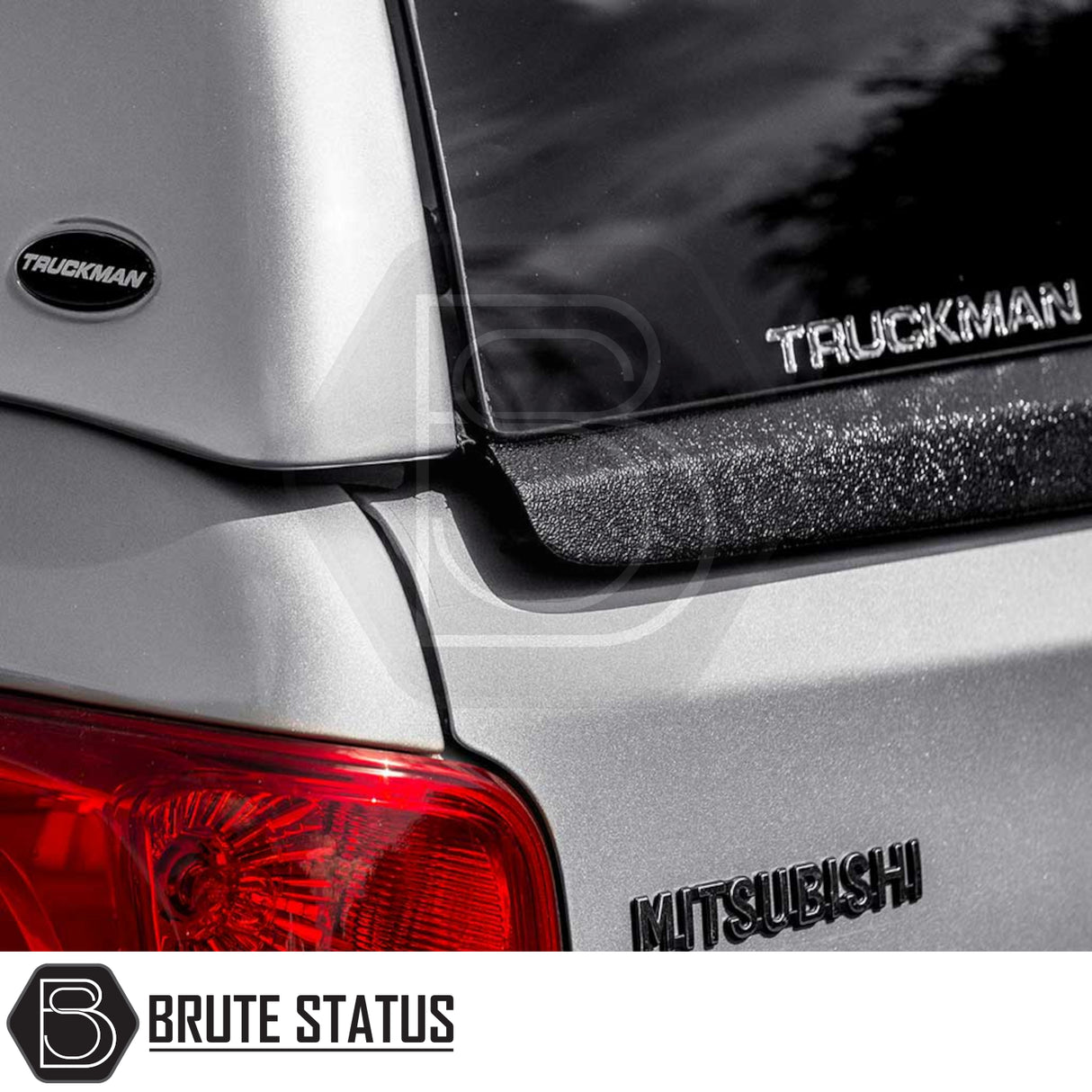 Rear corner of a silver Mitsubishi L200 with Truckman RS Hardtop Canopy featuring glazed rear window, remote locking, and visible Truckman logo.