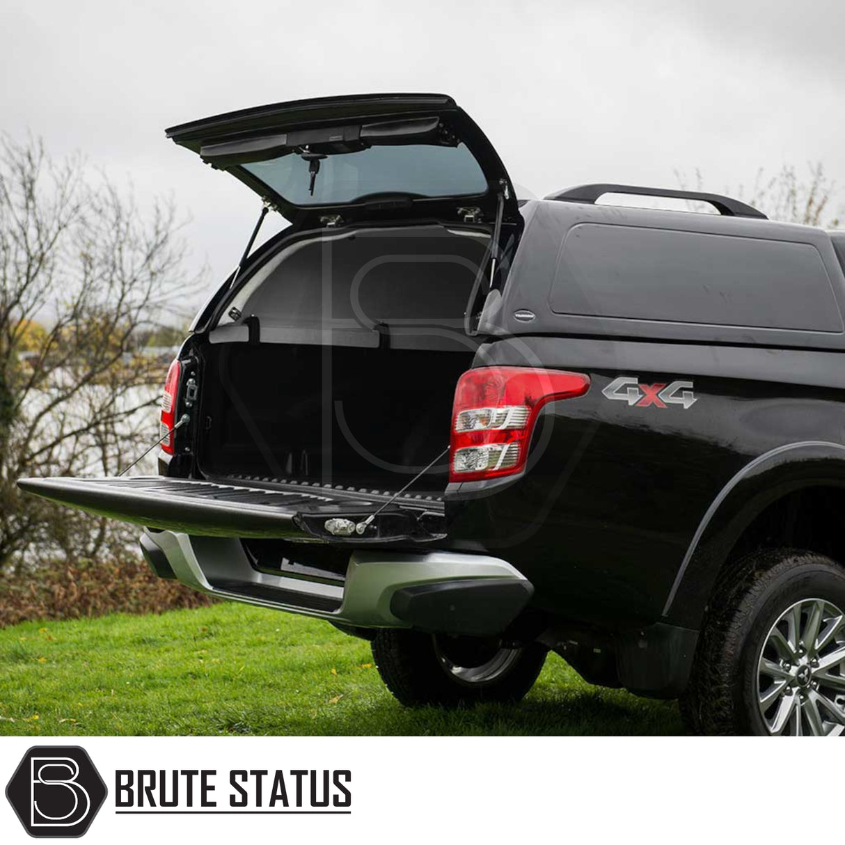 Black 4x4 pickup with open Truckman RS Hardtop Canopy, showing empty truck bed. Suitable for Fiat Fullback/Mitsubishi L200, Series 5/6, featuring glazed rear window, remote locking.