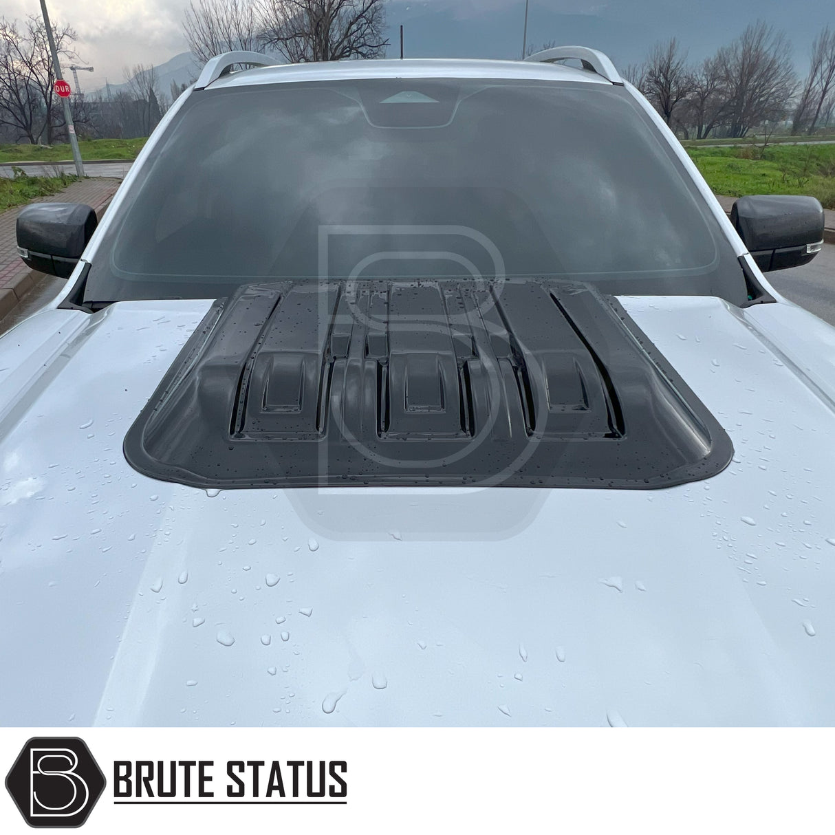 Ford Ranger T9 2023+ Raptor Style Bonnet Scoop Vent in gloss black, features matte-black vented hood scoop, raindrops visible, Brute Status logo present.
