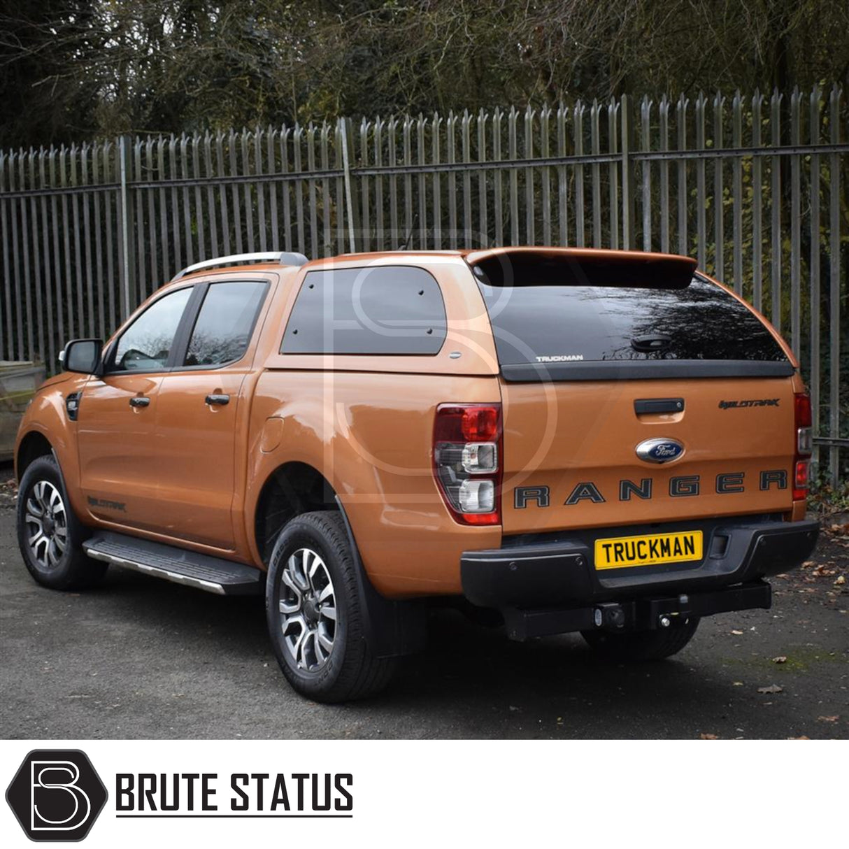 Orange Ford Ranger with Truckman Grand Hardtop Canopy featuring remote locking, tinted windows, and roof bars, enhancing cargo security and aerodynamics.