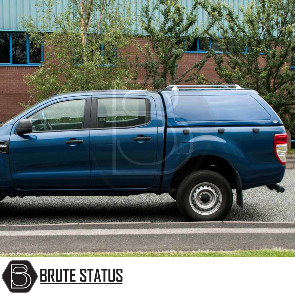 Ford Ranger 2012-2022 Truckman RS Hardtop Canopy with solid rear window, parked beside a road, enhancing security and utility for commercial use.