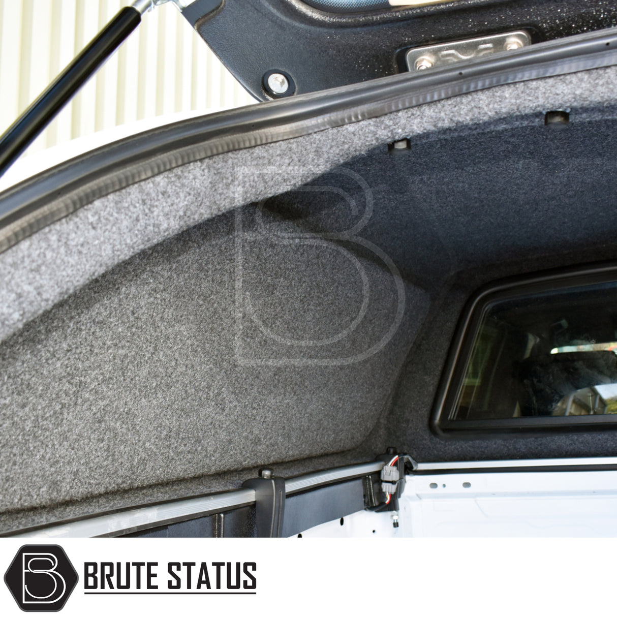 Interior view of Ford Ranger 2023+ T9 Truckman L-Series Hardtop Canopy, featuring grey carpet lining, sliding window, and gas-strut mechanism for enhanced security and functionality.