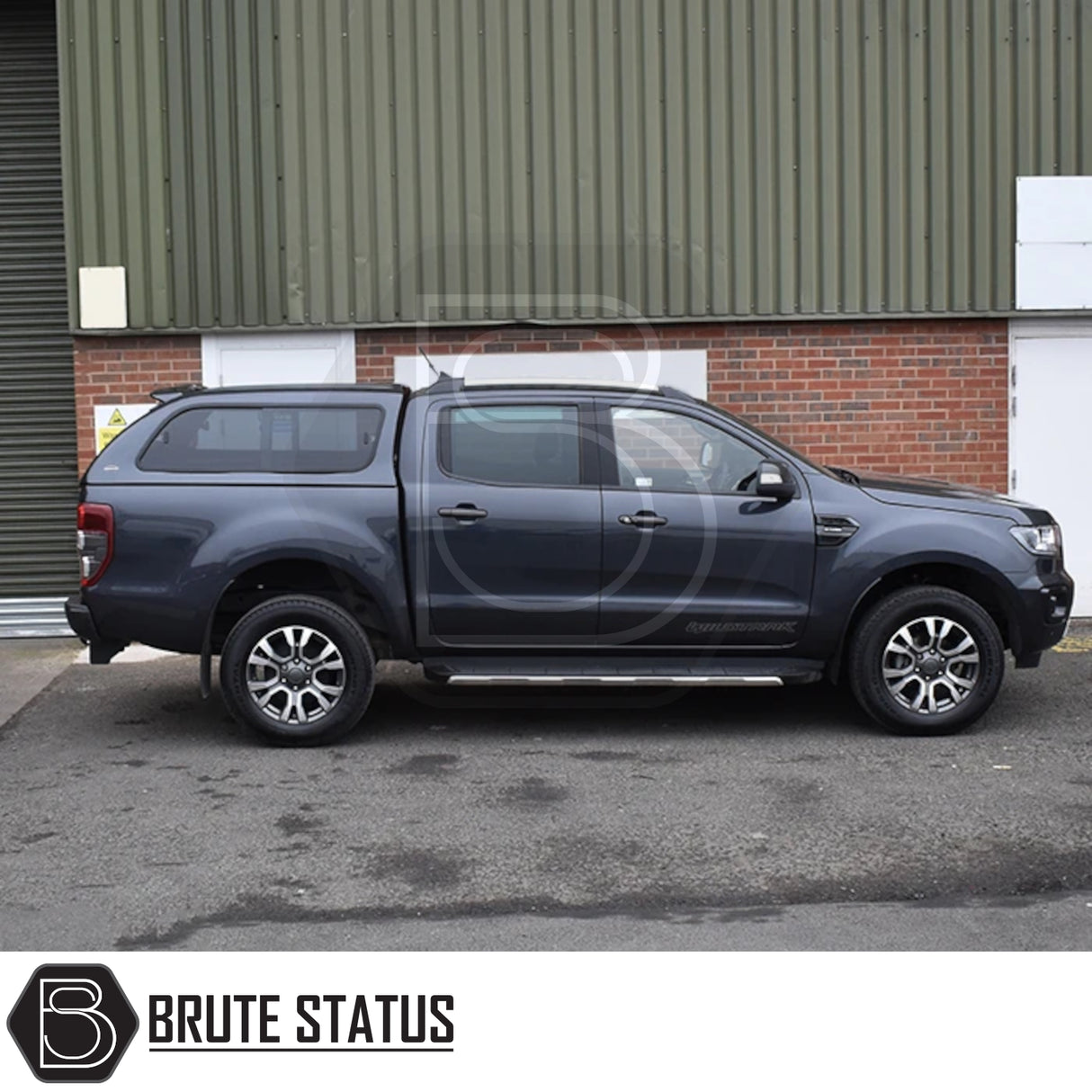 Ford Ranger pickup with Truckman GLS Hardtop Canopy featuring remote locking, tinted windows, and stylish design, parked near an industrial building.