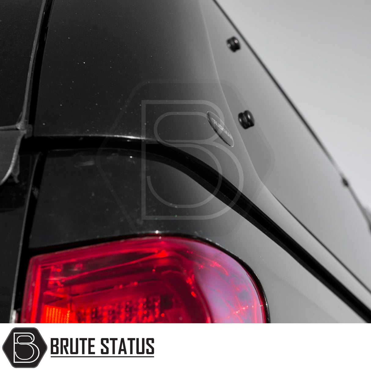 Close-up of Isuzu D-Max 2012-2021 Truckman Grand Hardtop Canopy with Brute Status “gen II” shell, highlighting rear corner, taillight, and Brute Status badge.