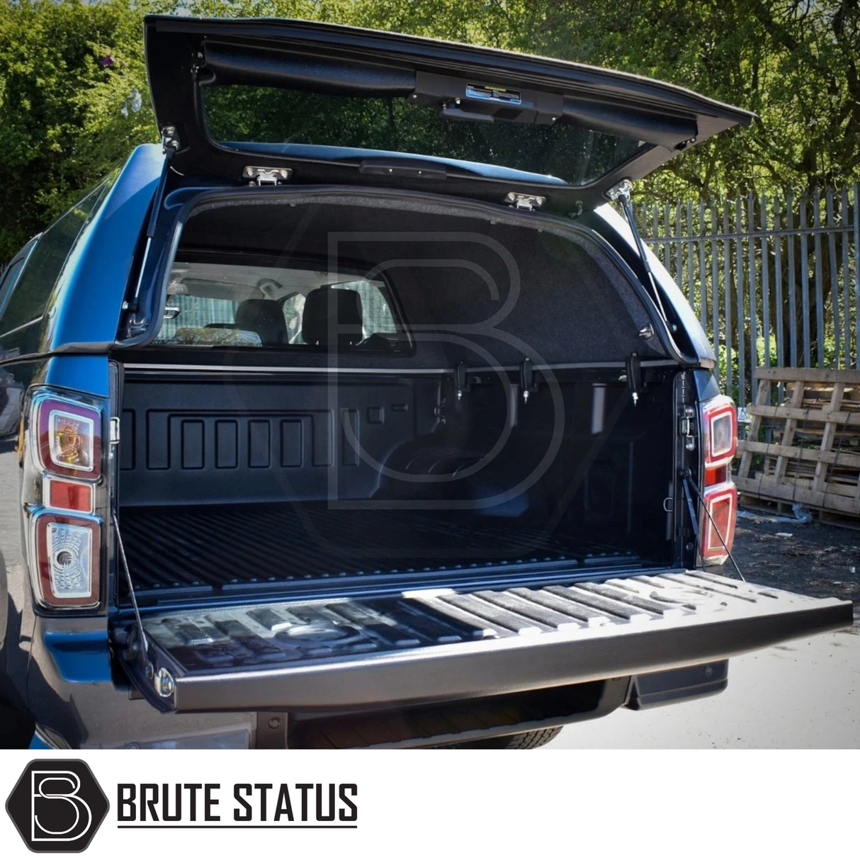 Isuzu D-Max 2025+ Truckman RS Hardtop Canopy with solid rear window and remote locking, showcasing open canopy and empty truck bed with molded liner and tie-down points.