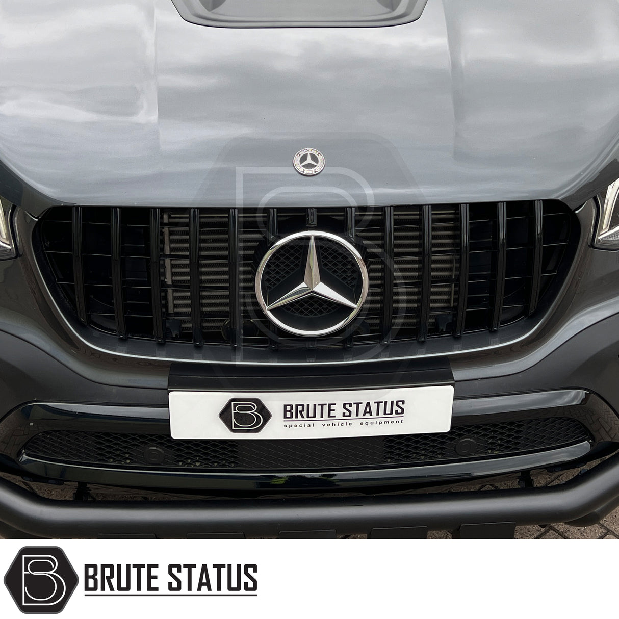 Mercedes X-Class AMG Panamerica Style Front Grille (All Black) installed on a white car, showcasing its sleek design and fitment, ideal for enhancing truck aesthetics.