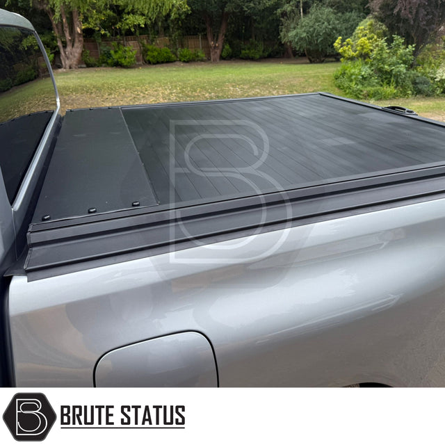 Black manual roller shutter for mitsubishi l200 2010-2014 pickup truck. Durable, high-quality design for secure cargo protection and easy manual operation