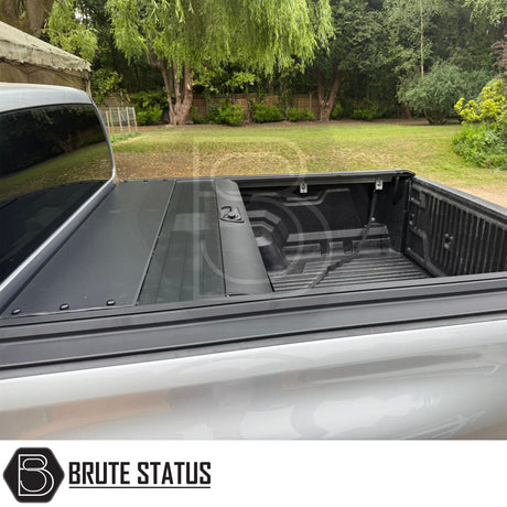 Black manual roller shutter for nissan navara D40 2005-2015 pickup truck. Durable, high-quality design for secure cargo protection and easy manual operation