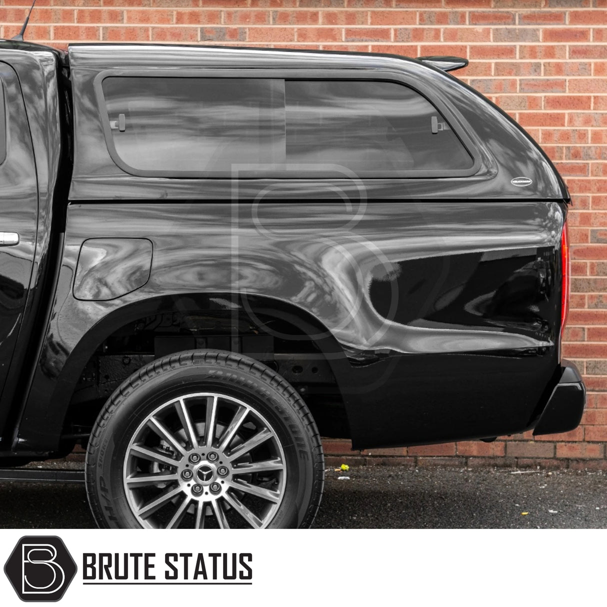 Mercedes X-Class 2017-2020 Truckman GLS Hardtop Canopy with remote locking and roof bars, enhancing cargo security and style, parked in front of a brick wall.