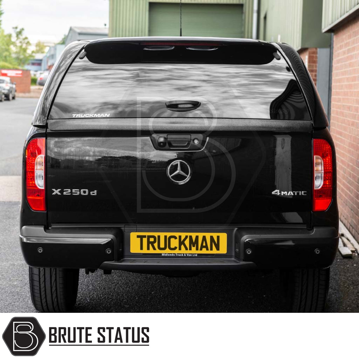 Mercedes X-Class 2017-2020 Truckman GLS Hardtop Canopy with remote locking and roof bars on a pickup, featuring a Brute Status watermark in an industrial yard setting.