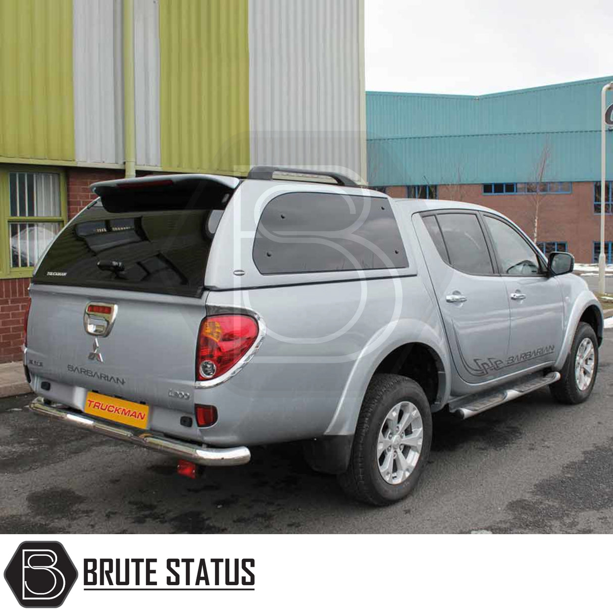 Silver Mitsubishi L200 2010-2015 Series 4 pickup with Truckman Grand Hardtop Canopy, featuring tinted pop-out windows and remote locking, viewed from driver’s side rear.