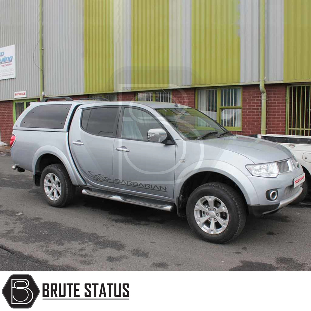 Mitsubishi L200 2010-2015 Series 4 Long Bed Truckman Grand Hardtop Canopy with remote locking, featuring tinted windows, roof rack, and chrome details on a parked double-cab pickup truck.