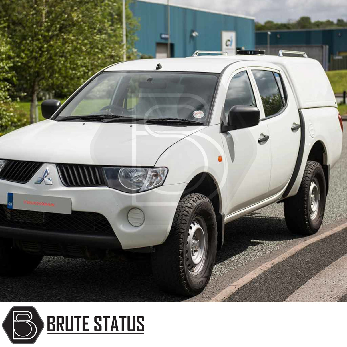 Mitsubishi L200 2010-2015 Truckman RS Hardtop Canopy with glazed rear window, ideal for secure, commercial use on parked white pickup truck.