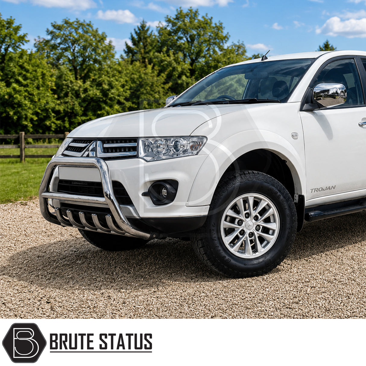 Front mounting heavy duty carbon steel chrome silver nudge bull bar fitted to white Mitsubishi L200 Series 5 pickup truck, offroad 4x4 vehicle. Suitable for overlanding set ups.