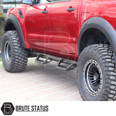 Mercedes X-Class 2017-2020 Heavy Duty T32 Steel Side Steps shown on a lifted red pickup, featuring fold-out design and wide fender flares for off-road enhancement.