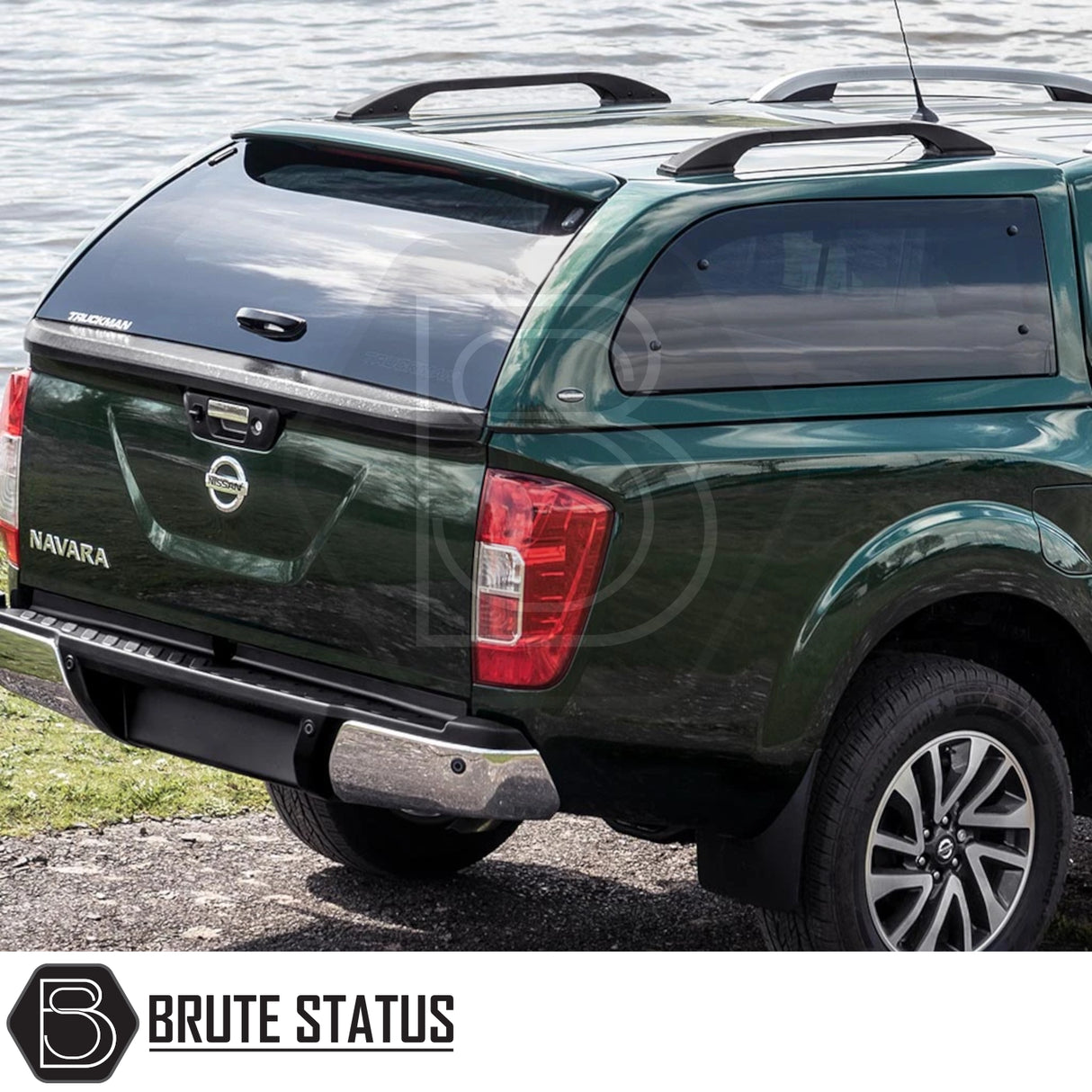 Nissan Navara 2005-2015 D40 Truckman Grand Hardtop Canopy with remote locking, featuring tinted windows and roof rails, parked by water.