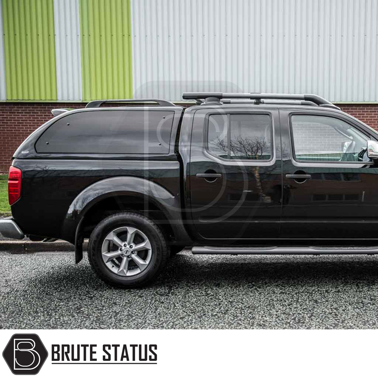 Side-view of a Nissan Navara 2005-2015 D40 fitted with a Truckman Grand Hardtop Canopy, showcasing roof rails, tinted pop-out windows, and remote locking.