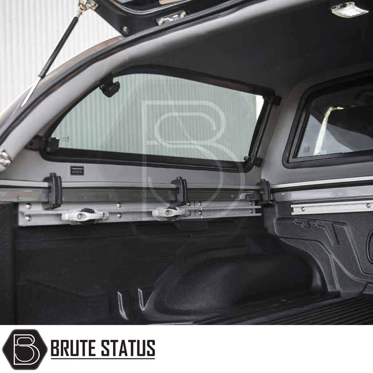 Nissan Navara 2005-2015 D40 Truckman Grand Hardtop Canopy with load-securing system, featuring black bed liner, tie-down rails, and adjustable anchors.