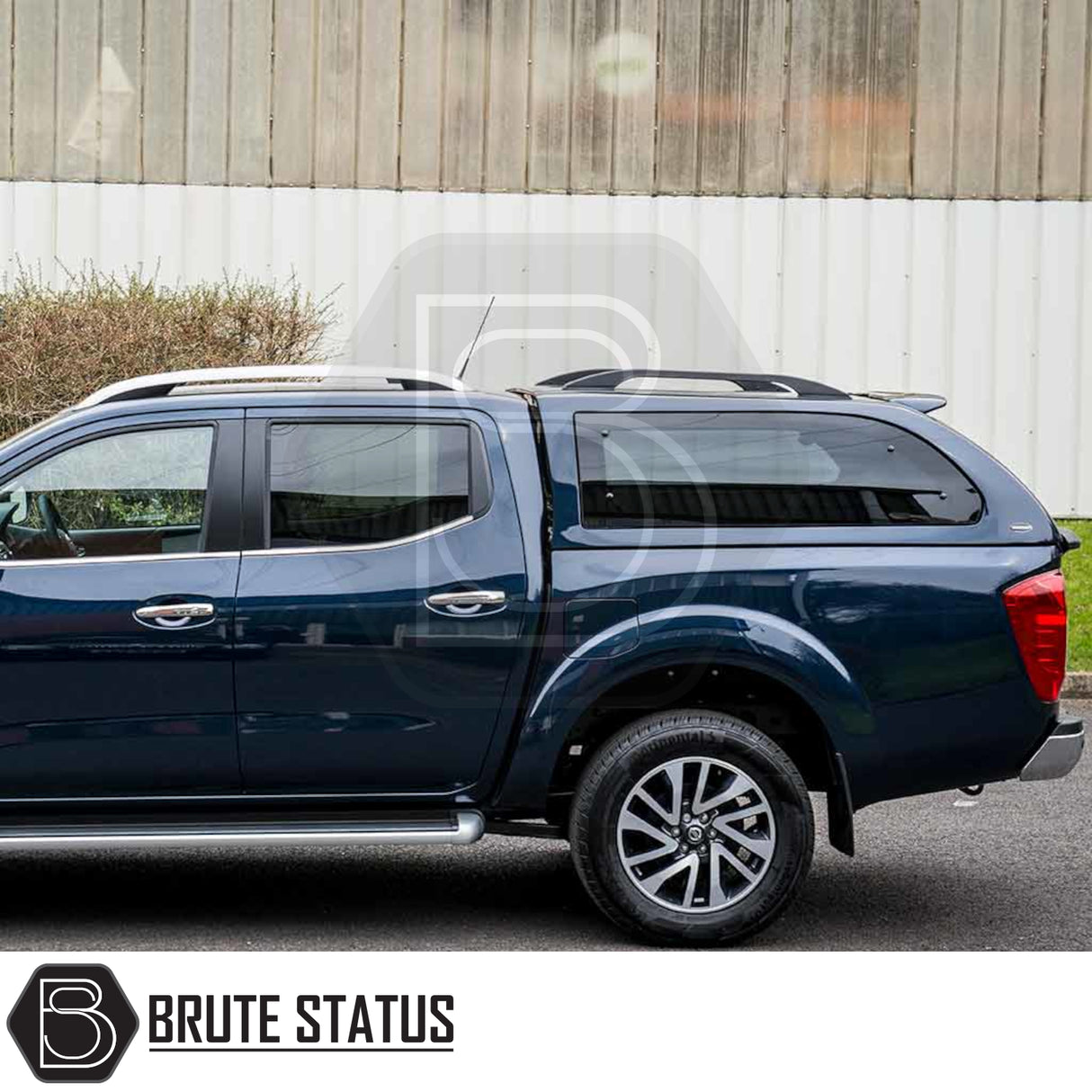 Nissan Navara 2005-2015 D40 Truckman Grand Hardtop Canopy with remote locking, featuring a cab-high design and pop-out tinted windows, installed on a pickup truck.