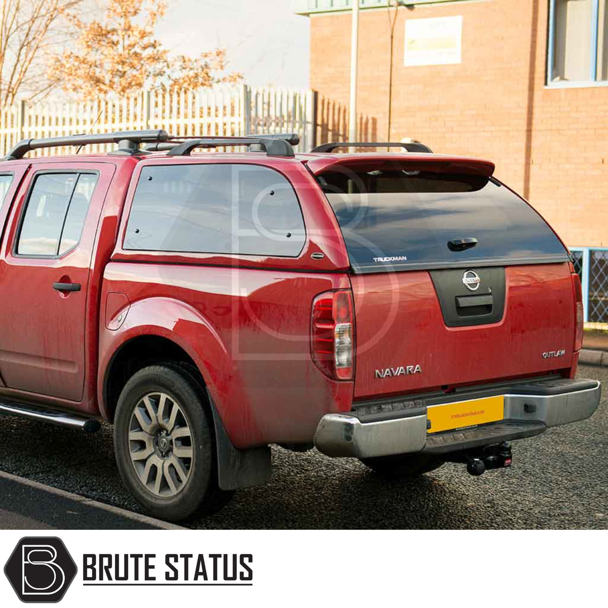 Rear view of a red Nissan Navara with a Truckman Grand Hardtop Canopy, featuring remote locking and pop-out windows, highlighting increased secure storage.