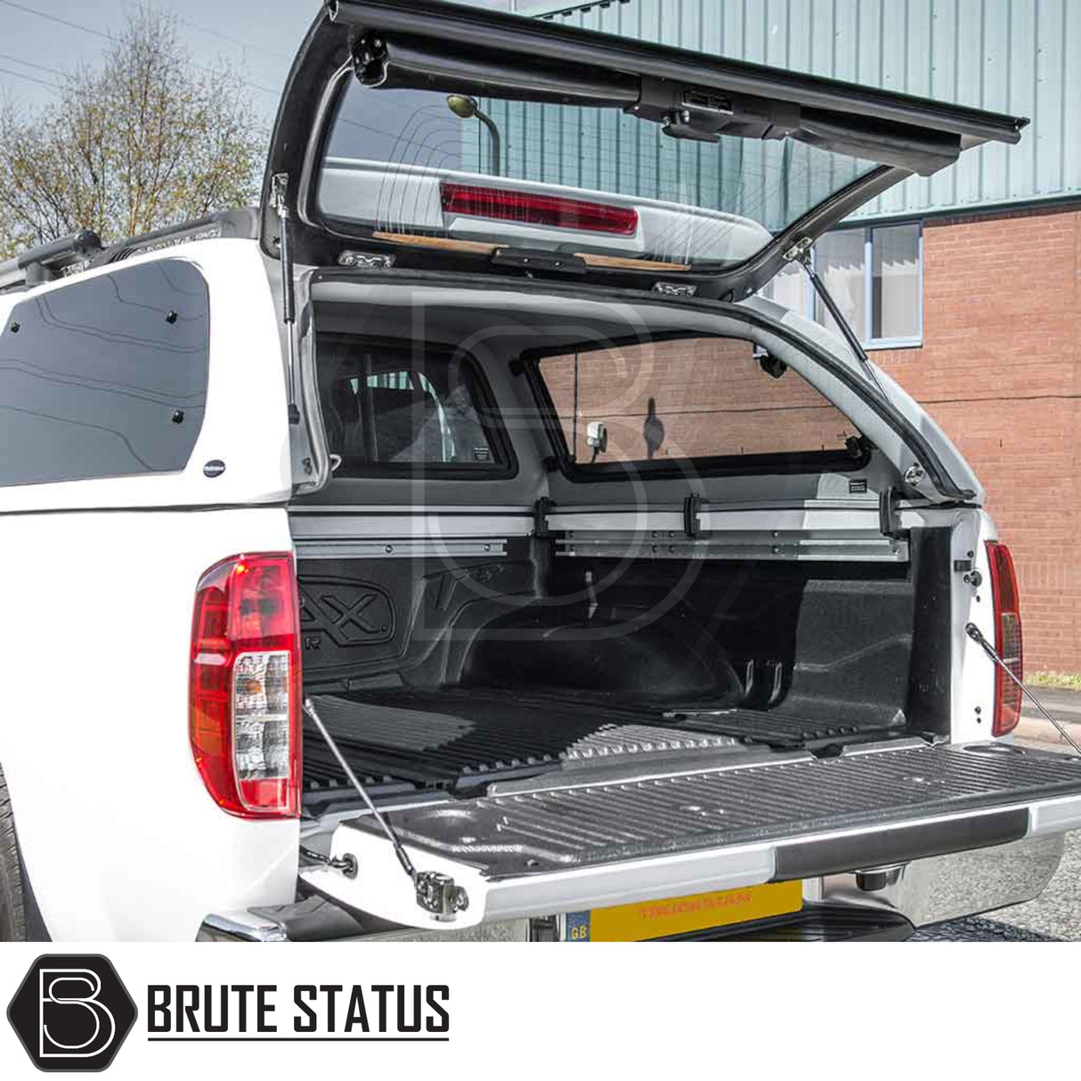Nissan Navara 2005-2015 D40 Truckman Grand Hardtop Canopy with remote locking, revealing a spacious, lined truck-bed interior and load-rail system.