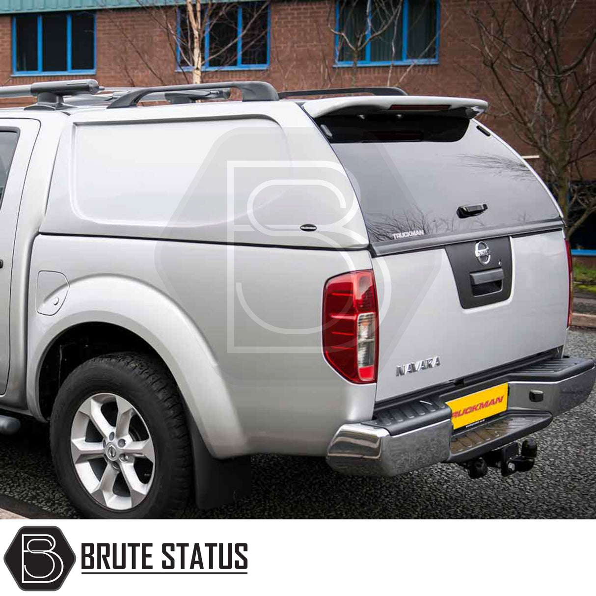 Silver Nissan Navara D40 with Truckman L-Series hardtop canopy, featuring seamless design and remote locking, enhancing truck bed security and storage.
