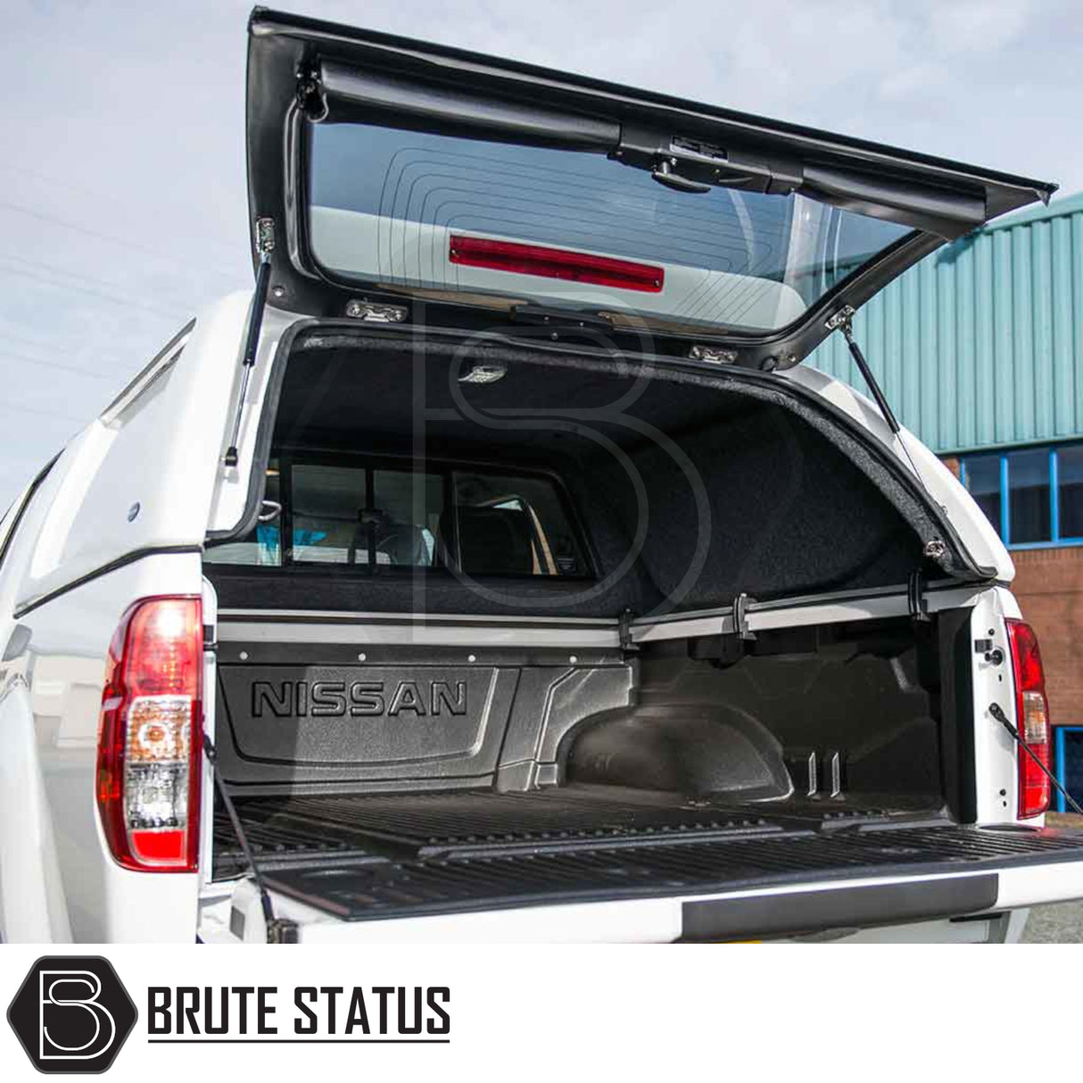 Nissan Navara 2005-2015 D40 Truckman L-Series Hardtop Canopy, open rear view with raised hatch, showcasing carpet-lined cargo space under lockable canopy.