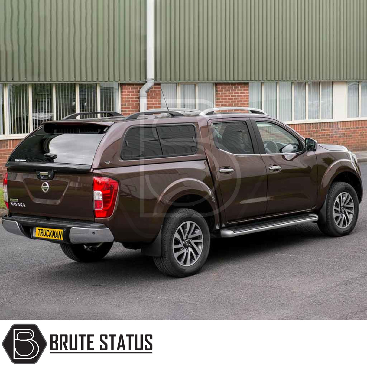 Nissan Navara 2015-2023 NP300 with a Truckman GLS hardtop canopy, featuring remote locking and sliding windows, parked beside a brick building.