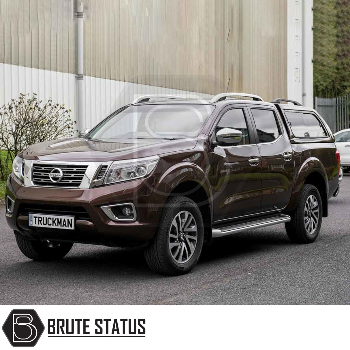 Nissan Navara NP300 with Truckman GLS hardtop canopy featuring remote locking, parked by a warehouse.