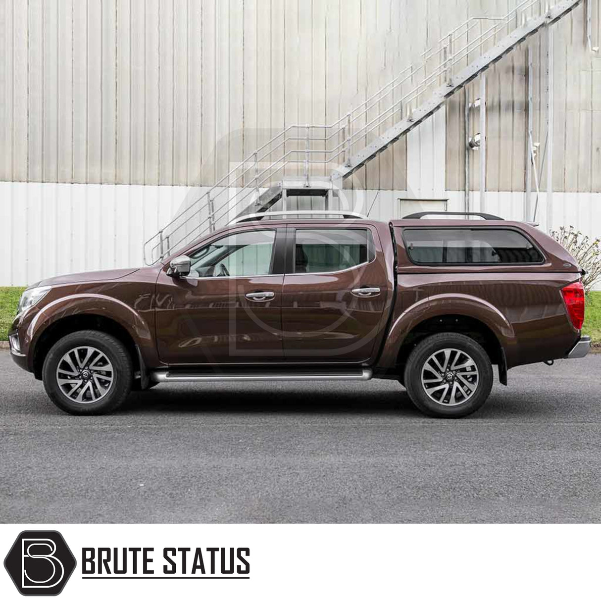 Nissan Navara 2015-2023 NP300 Truckman GLS Hardtop Canopy - Remote Locking, featuring lockable tinted sliding windows, parked by an industrial building.