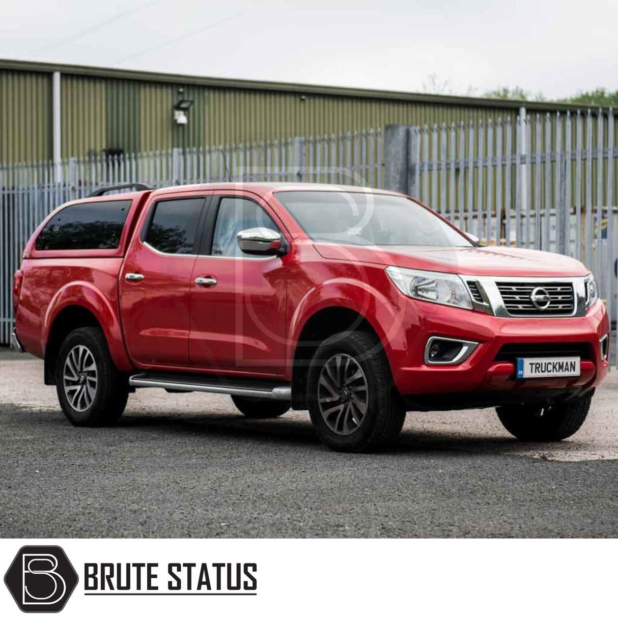 Nissan Navara with Truckman Grand Hardtop Canopy, featuring remote locking, parked near industrial fence; showcases streamlined, secure, and stylish design enhancements for pick-up trucks.
