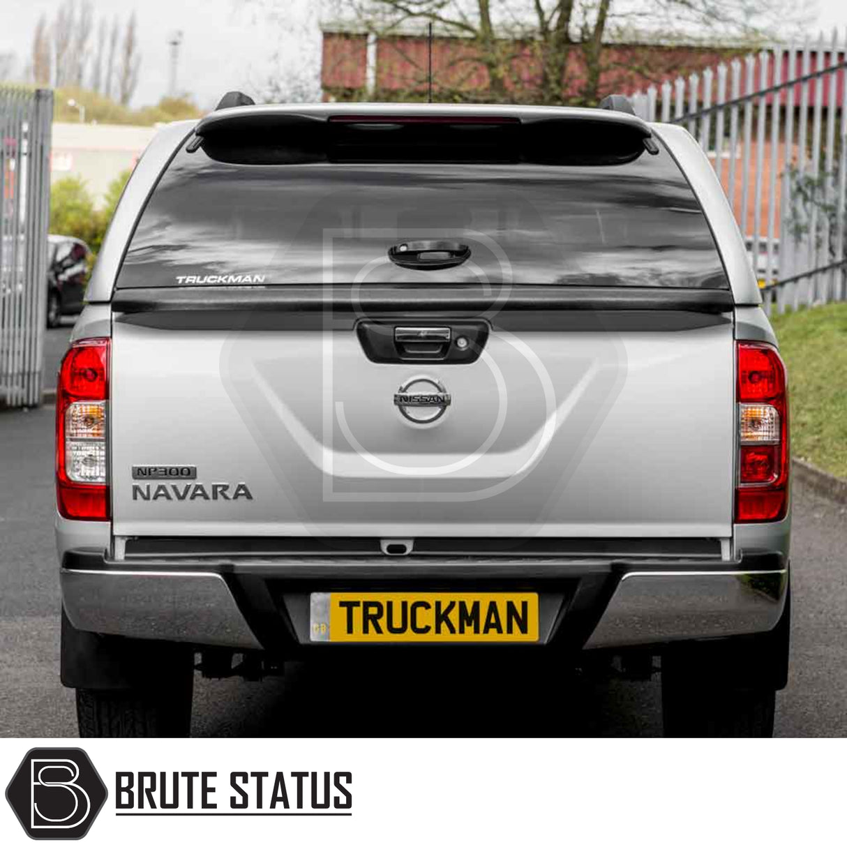 Silver Nissan Navara NP300 with Truckman Grand Hardtop Canopy, featuring remote locking and pop-out windows, enhancing storage and security. Tailgate displays model and canopy branding.