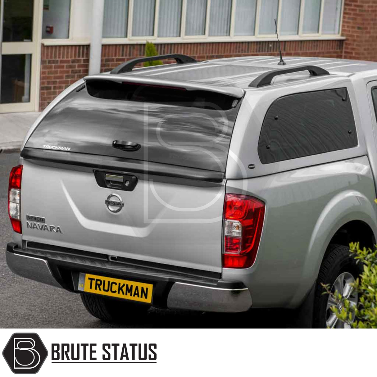 Silver Nissan Navara NP300 with Truckman Grand Hardtop Canopy, featuring lockable tinted windows and remote locking, enhancing storage and security.