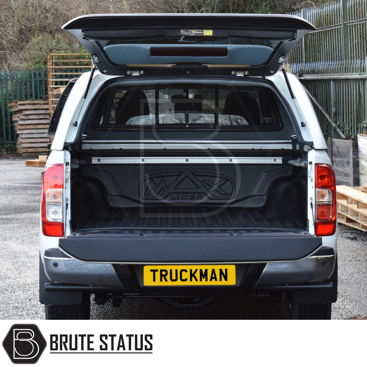 Nissan Navara NP300 with Truckman Grand hardtop canopy, rear open showing empty cargo bed with MAX liner, highlighting canopy's remote locking and increased storage.