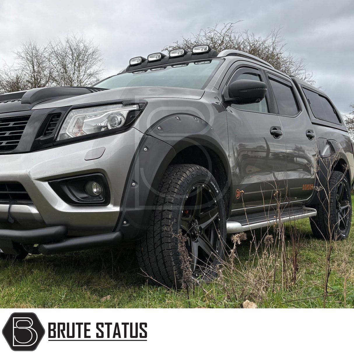 Strong matte black wing mirror covers fitted onto Nissan Navara NP300 pick up truck, offroad 4x4 vehicle.