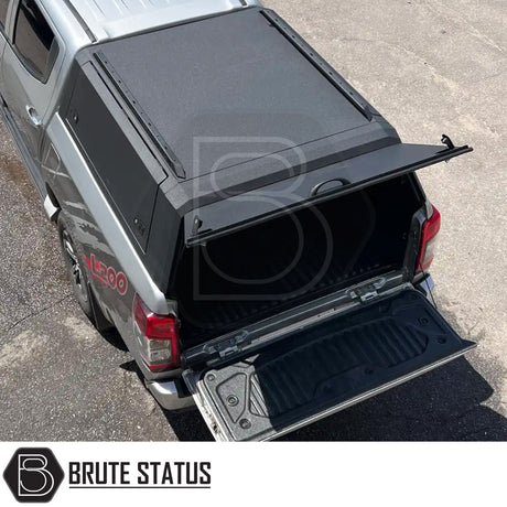 Heavy-duty steel rear canopy with Line-X coating, multi-access doors, and roof rails for Toyota Hilux 2015+ pickup truck